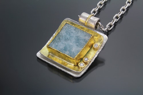 hand made gold and silver pendant with a square aquamarine by Sana Doumet