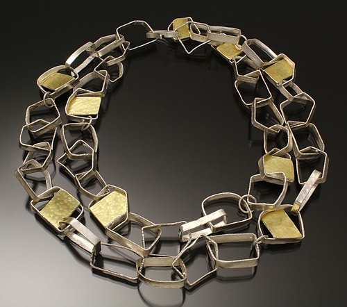 silver and gold linked necklace by Sana Doumet