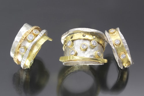 three hand made diamond studded silver and gold rings by Sana Doumet