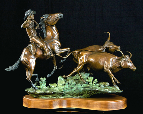 bronze sculpture of a cowboy on horseback herding cattle by Rick Hill