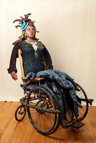 mixed media sculpture of a Medusa in a wheelchair by A. Laura Brody