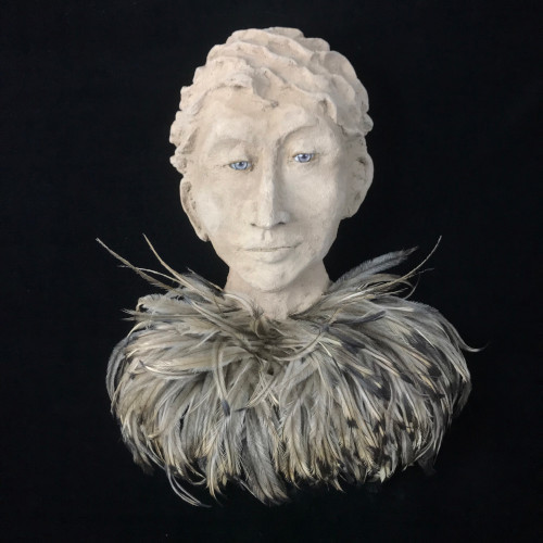 concrete sculpture portrait of a man with an emu feather collar by Barbara Liss