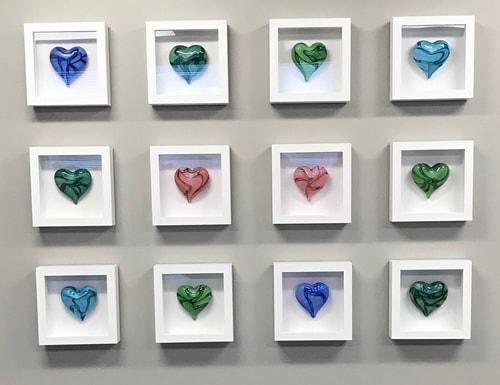 blown glass hearts in shadow boxes - wall installation by Jake Pfeifer