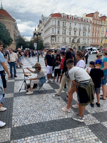 Artist Marilyn Simandle painting in Prague's Old Town Square