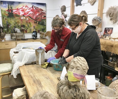 Artists working in sculpture studio