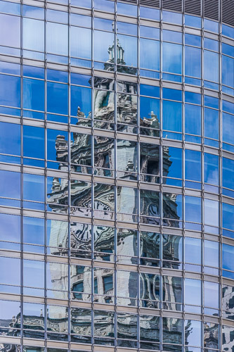 photograph of a building in Chicago reflected in another building by Lauri Novak
