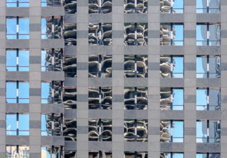 photograph of a Chicago building reflected in anothe building by Lauri Novak