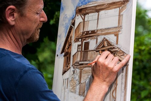 Artist at work on an easel