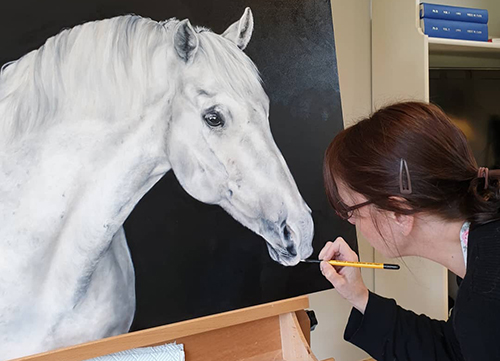 artist Nikki Carr with her painting "Jasper"