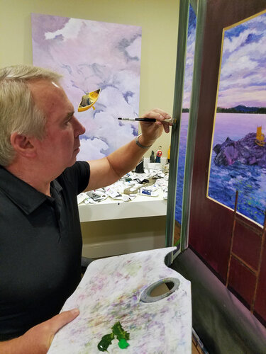 Artist Tom Blood painting in his studio