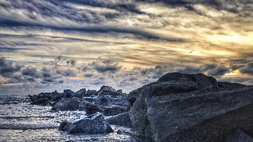 photography of a rocky shore by Kim Ramsey