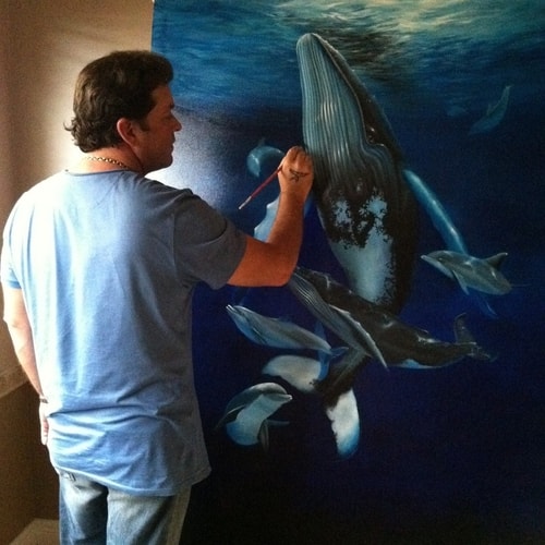 Artist Michael Alexander in his studio at work on a painting