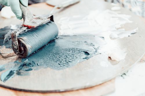 Artist Brigitte Balbinot in her studio with a brayer