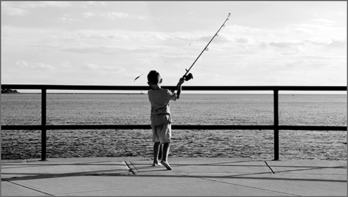 photo of a boy fishing by Nubar Alexanian