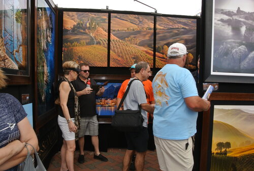 Fairgoers view the work of photographer John Scanlan at ArtFest Fort Myers