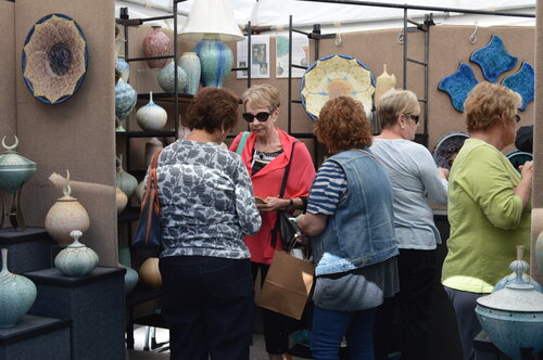 Shoppers at the Pottery Boys booth at ArtFest Fort Myers