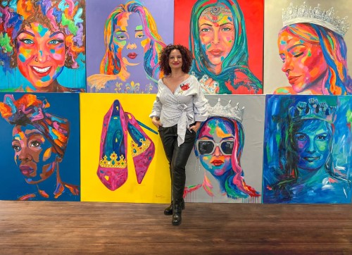 Artist Ramona Pintea with her paintings