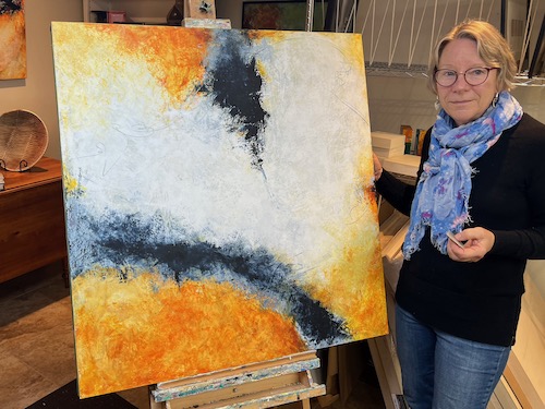 Artist with her painting