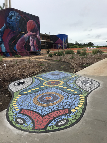 Dragon head mosaic installation by Paul Perry