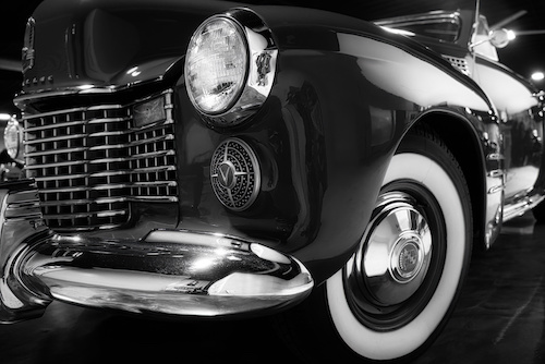 Black and white closeup photo of a vintage car