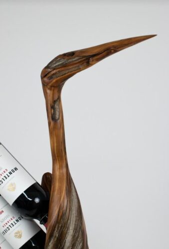 detail of handcarved heron wine rack