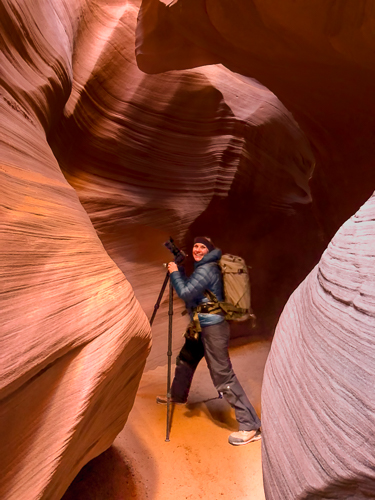 Photographer setting up a camera in a canyon