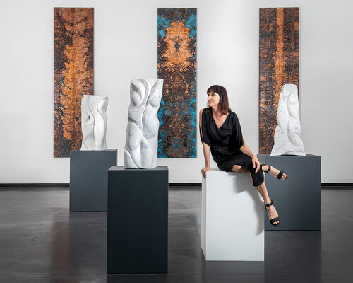 Sculptor Christina Bertsos with a grouping of her marble sculptures