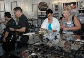 people shopping in an artists's booth