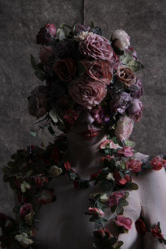 surreal photo of a woman covered in roses by Paul Watson