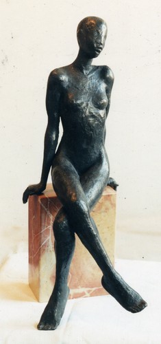 bronze sculpture of a woman sitting