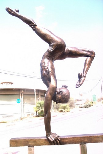 Bronze sculpture of balance beam gymnast