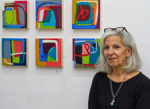 Artist Donna Horn with her paintings