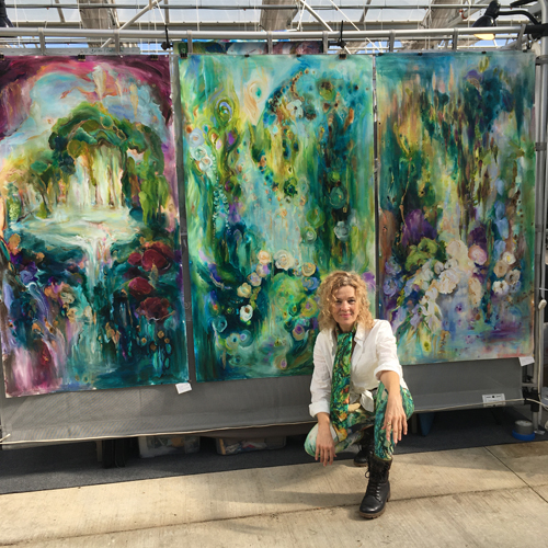 Artist Bettina Madini with her paintings