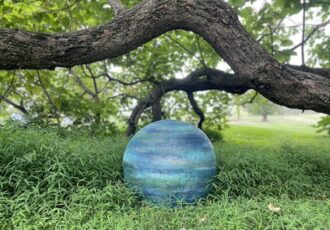 Blue painted cement sphere