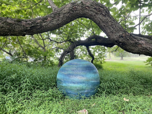 Blue painted cement sphere