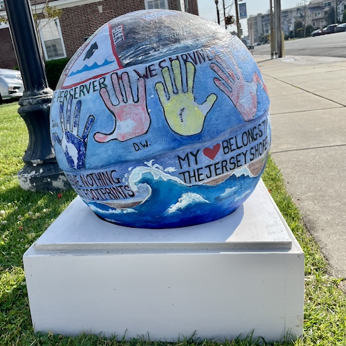 Cement sphere painted with community based art
