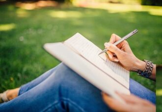 woman writing in a book