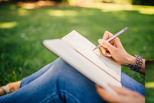 woman writing in a book