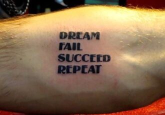 Tattoo on the arm of artist Sam Bernal, Dream, Fail, Succeed, Repeat