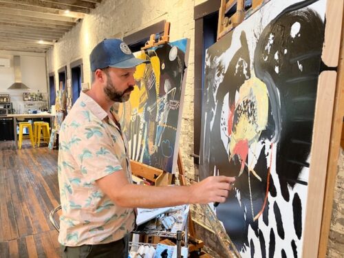 An artist painting in his studio