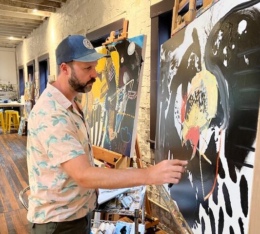 An artist painting in his studio