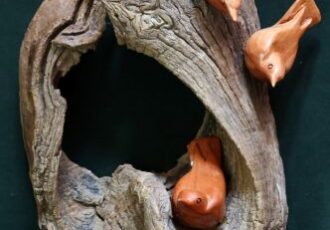 wooden sculpture of nutches on a tree