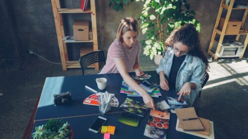 two women reviewing a portfolio