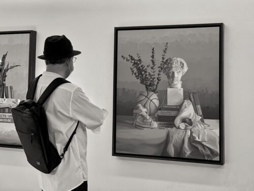 man viewing art for sale