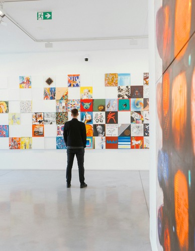 man viewing art in a gallery