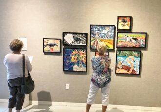 women viewing an art exhibition